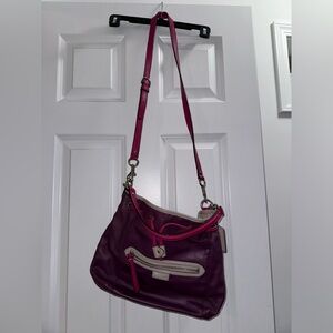 Purple and pink coach crossbody purse.